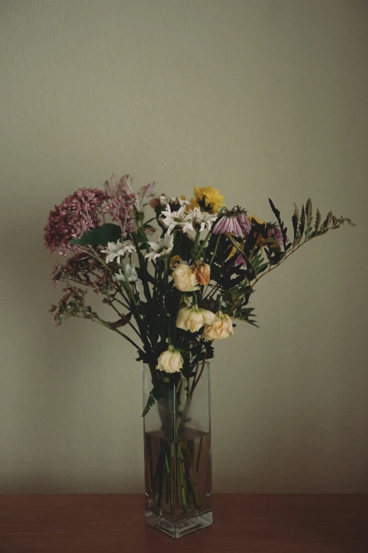 a vase that has flowers inside it on a table