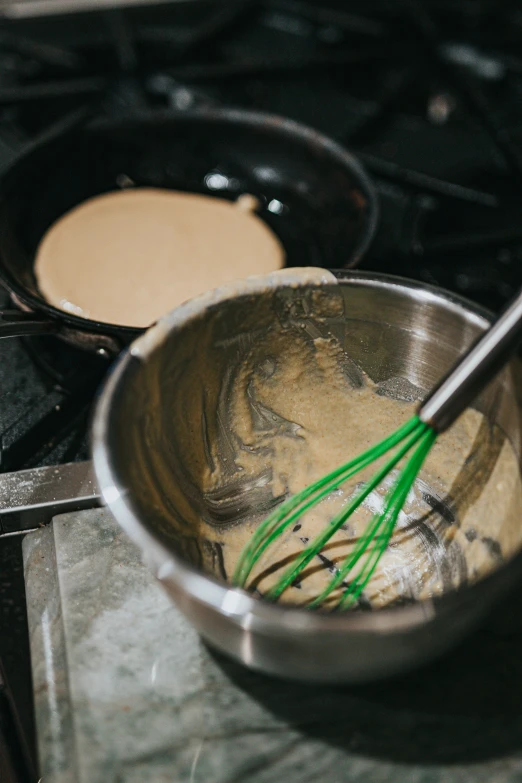 a bowl with green food in it and a spoon