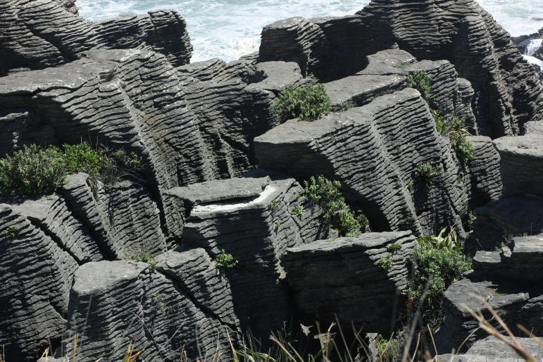 an image of rocks with water in the background