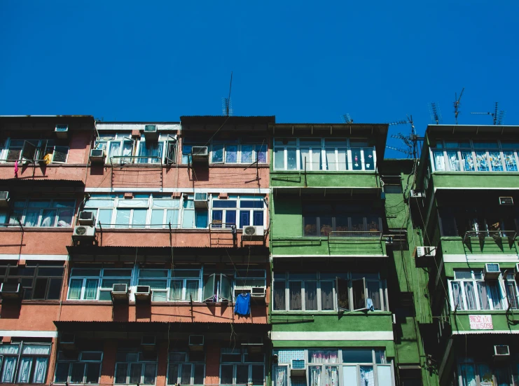 an apartment building in the middle of an intersection with clothesline on the clothes line