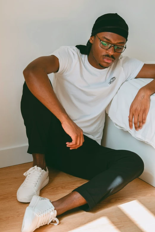 a person sitting on the ground wearing black leggings