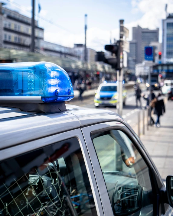 a police car is stopped at an intersection in the city