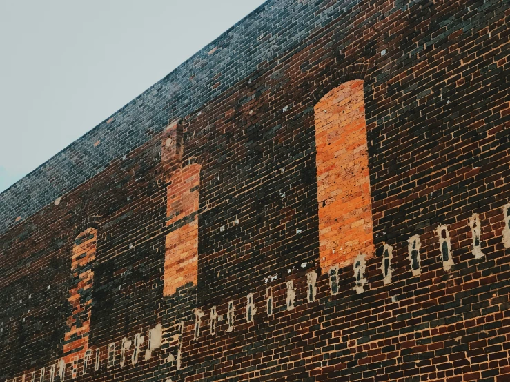 a brick wall that has signs on it