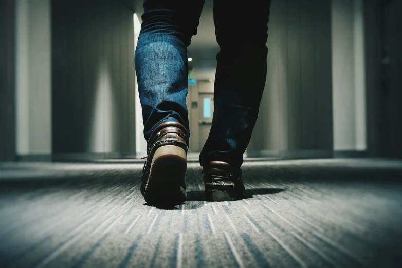 closeup of a persons feet walking in the hallway