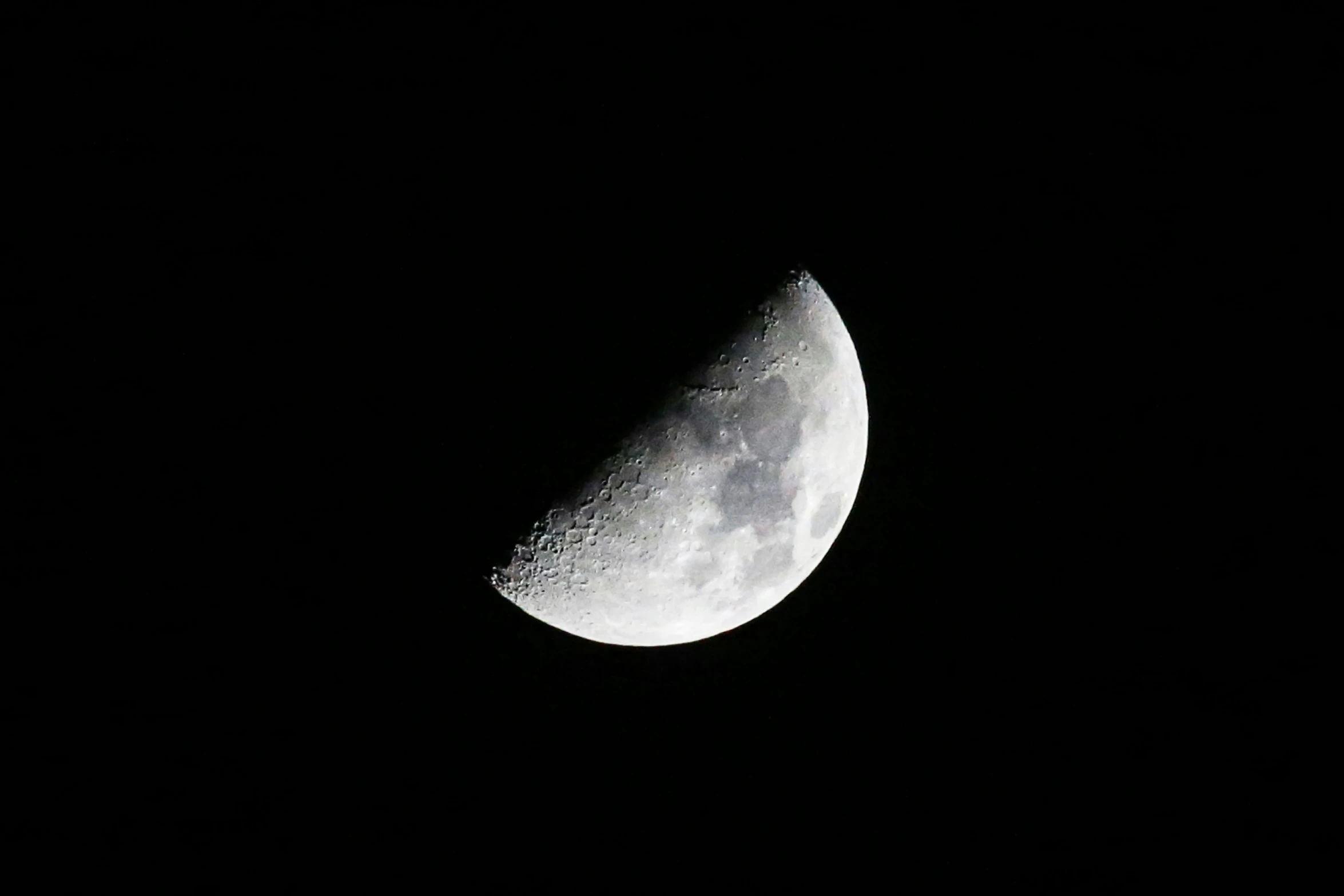 a crescent moon is visible in the dark sky