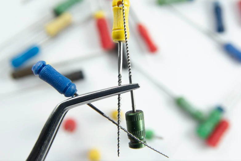 a miniature clock made with screws and needles