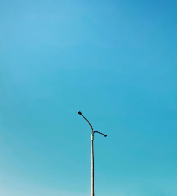 two people on a motorcycle next to a street light