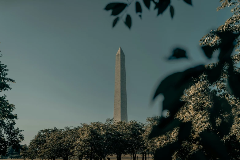 a view of a very tall white building with a spire in the distance