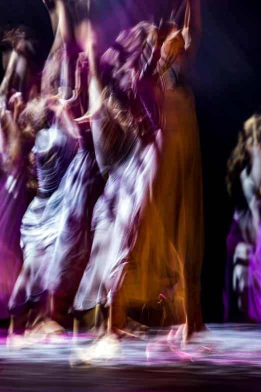 blurred motion pograph of dancers in a dress on stage