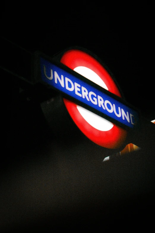 a blue sign with white lettering reading underground