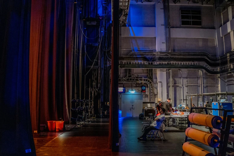 a view of a dark building from an area that has many orange pipes in it