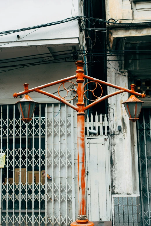 an old - fashioned street lamp stands in front of the front of a building