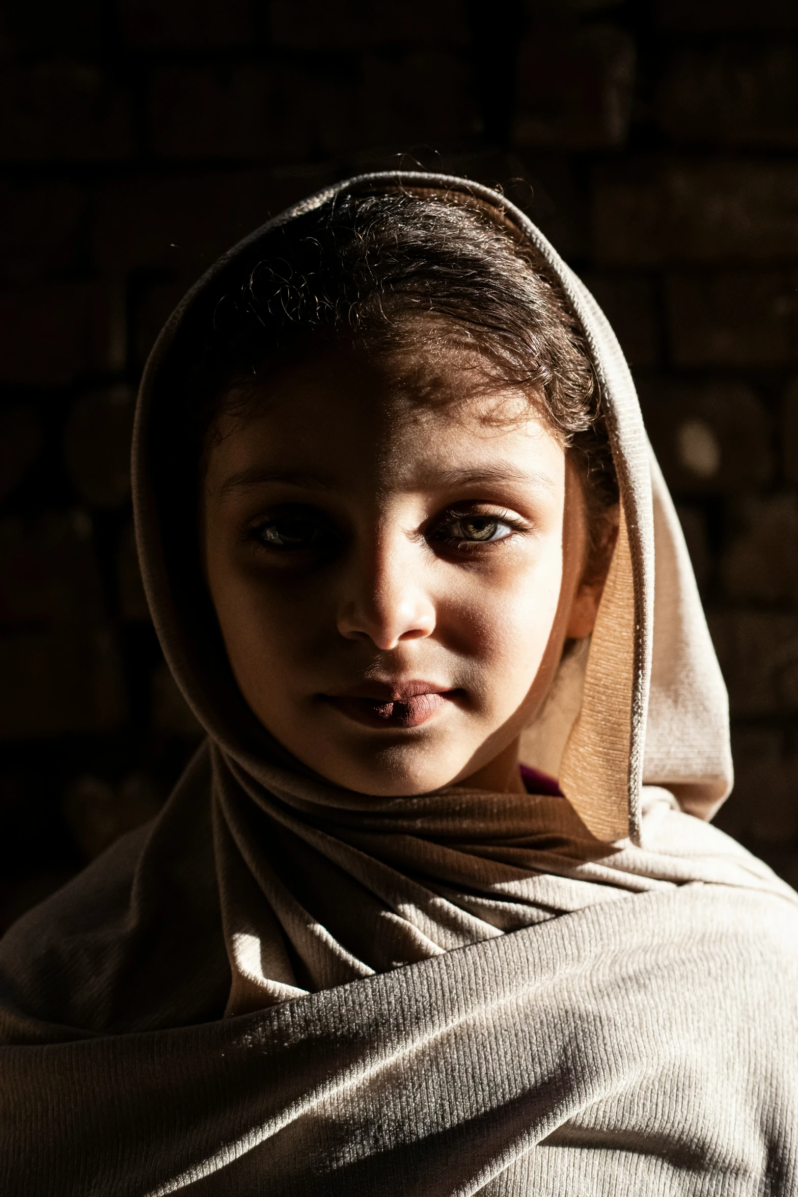 a child wearing a nun's headdress poses for a pograph