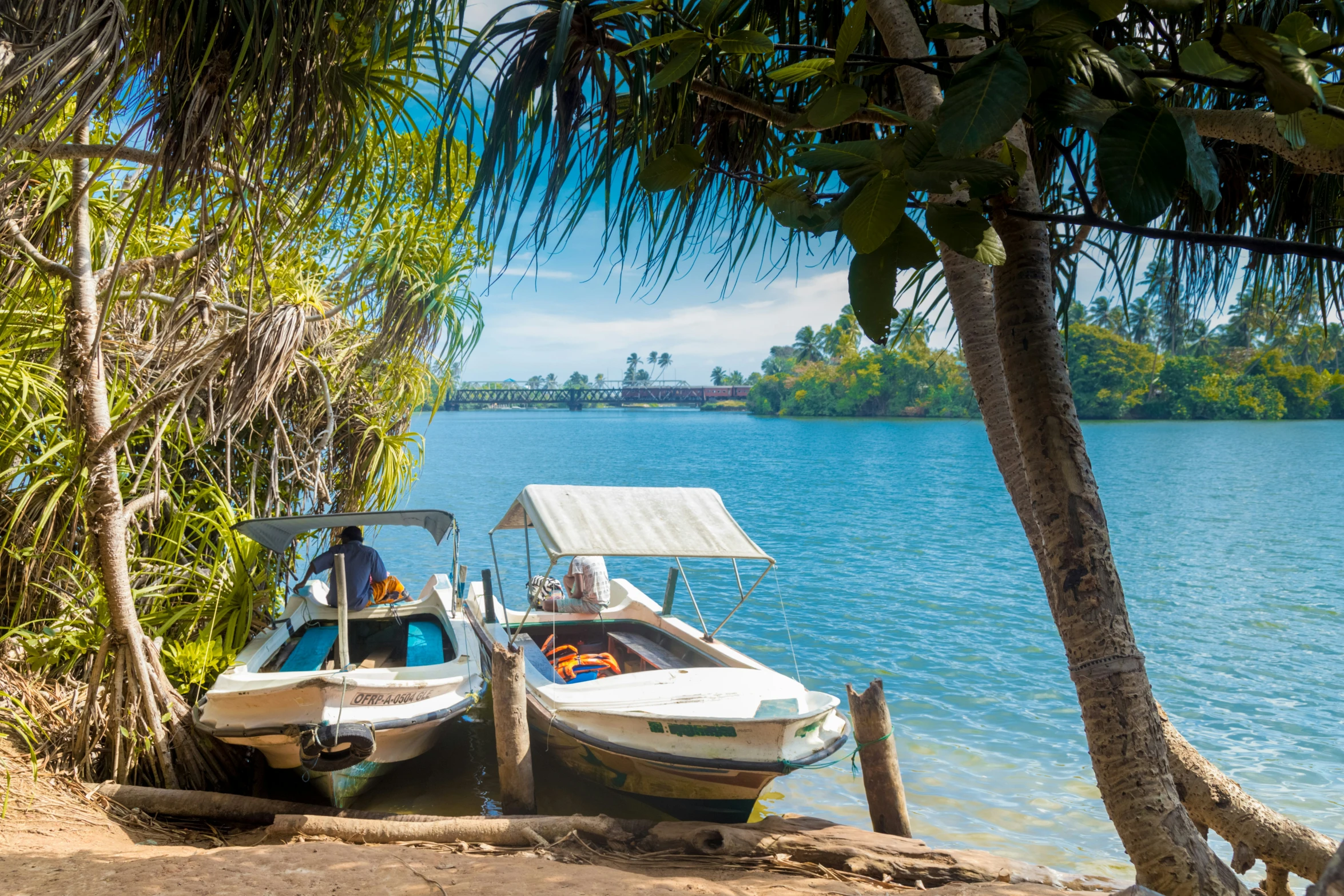 a boat tied up to the shore of a lake