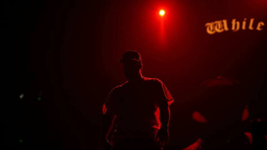 a person standing at the top of a dark stage