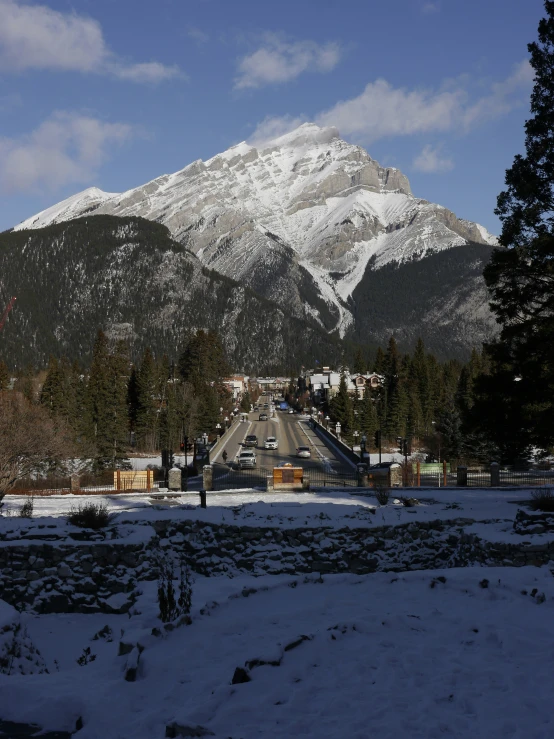 a street sign in front of some snow covered mountains