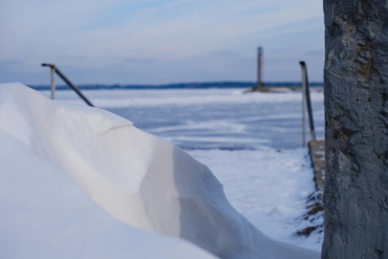 an image of the beach and the ocean covered in snow