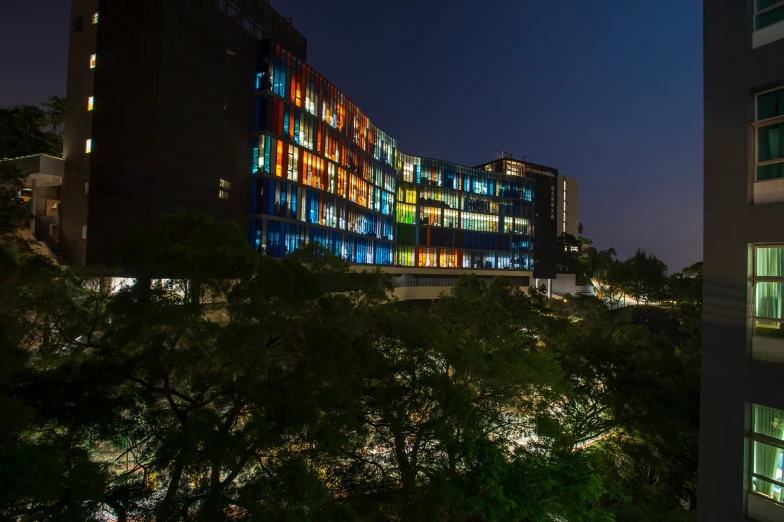 a building with brightly colored lights is shown at night