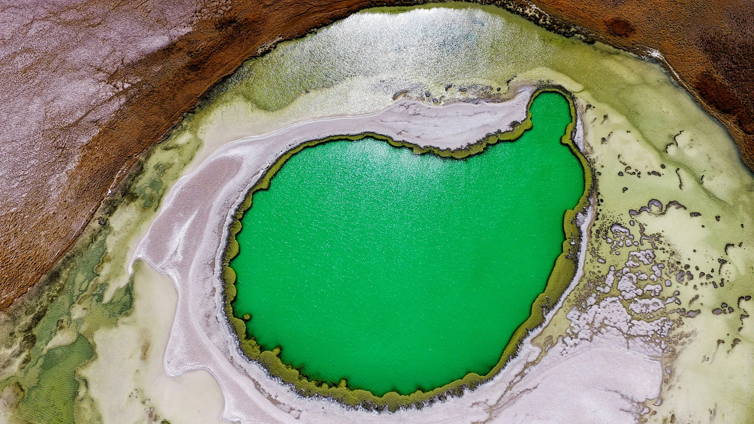 an aerial view of a lake surrounded by land