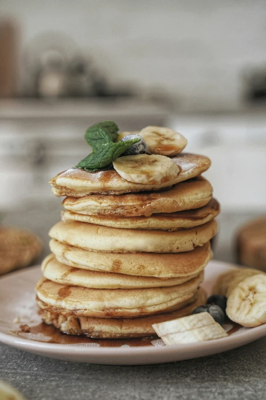 a stack of banana pancakes on a white plate