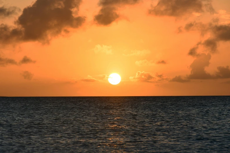 sunset in the distance as seen from a ship