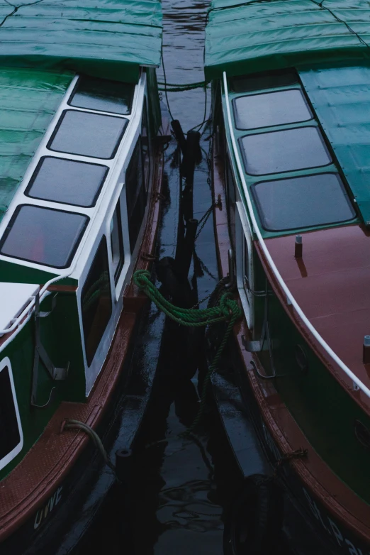 two small boats in the water beside each other