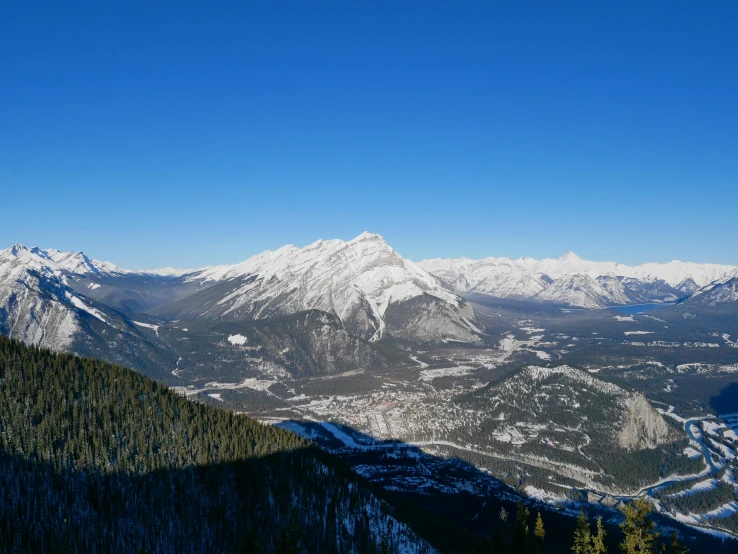 a snowy mountain top sitting on the side of a road