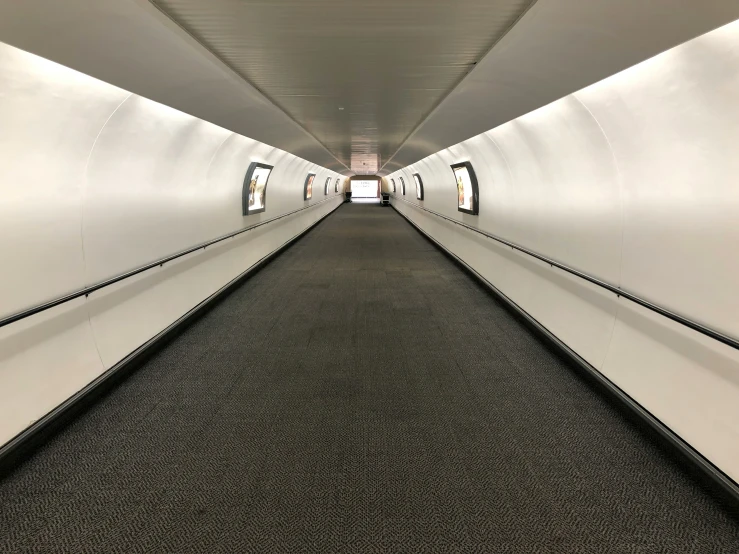 an empty white tunnel with no people in it