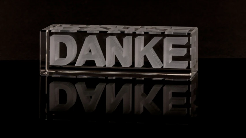 a block with danke written in metal