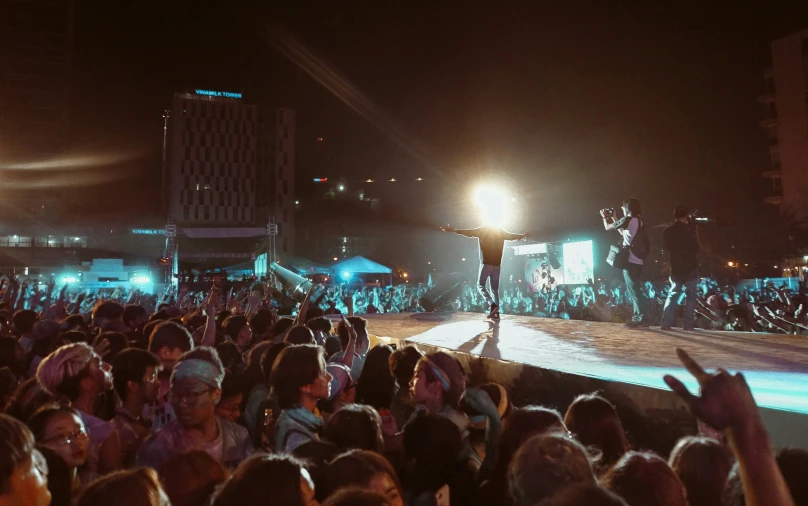 the crowd is enjoying the night at a concert