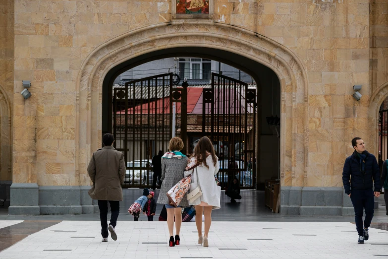 a group of people walking into a building