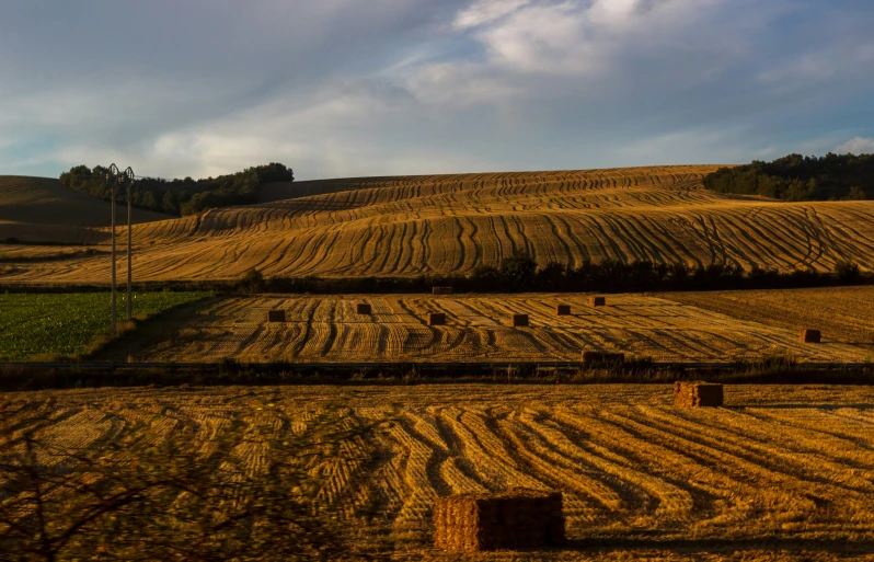 hay fields near a hill in rural countryside