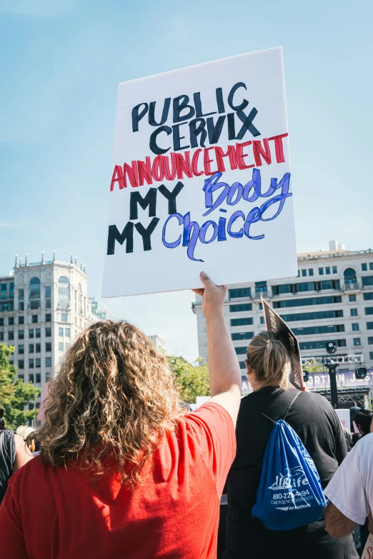 a group of people stand together holding signs