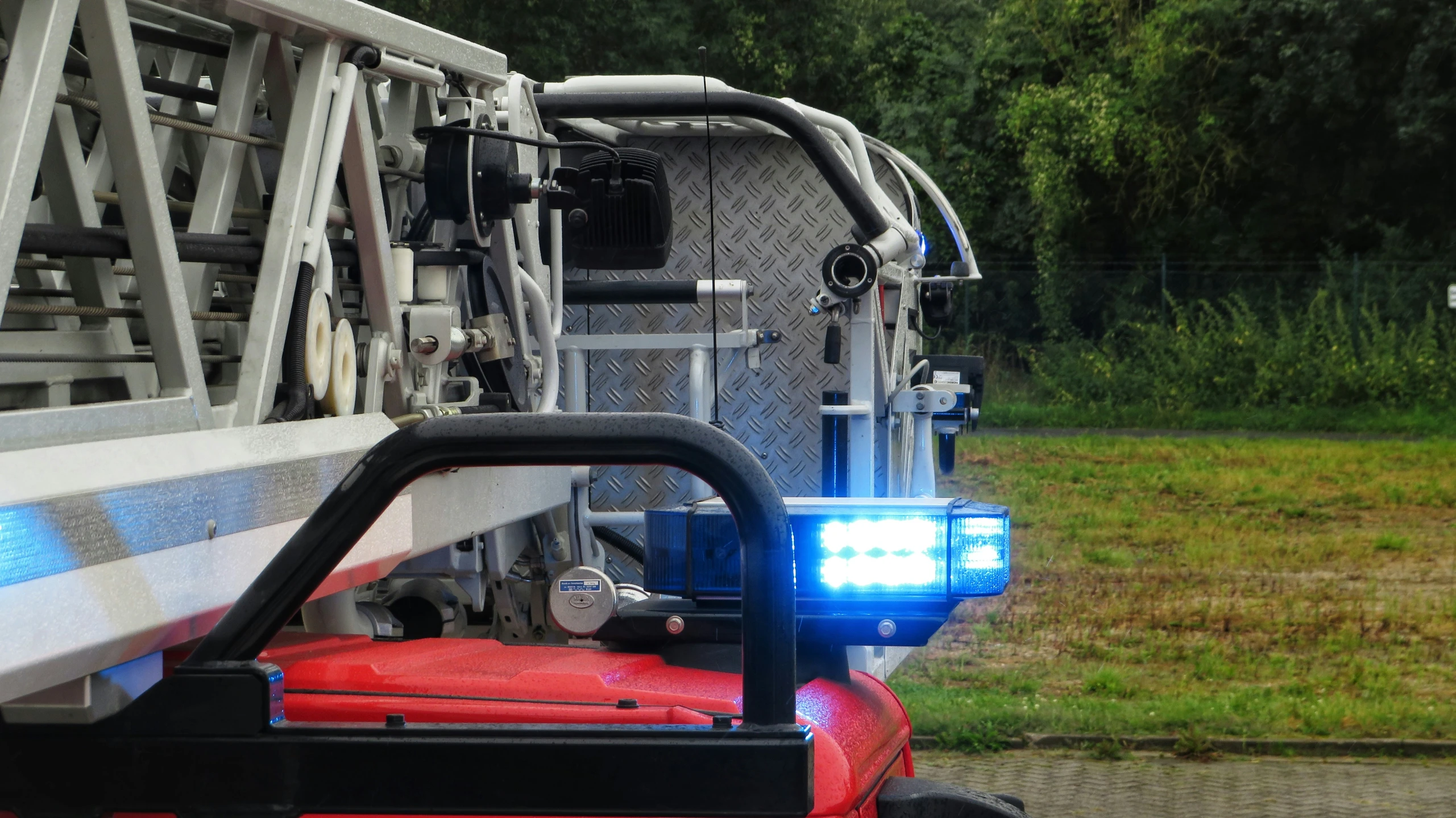 a truck with lights on sitting by the side of the road