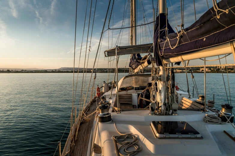 a boat with sails sailing in the water