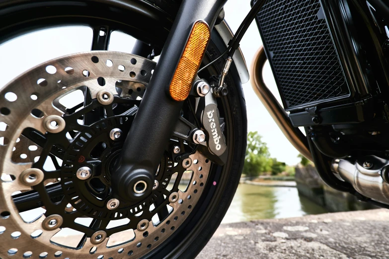 close up of a motorcycle tire with its ke and front wheel