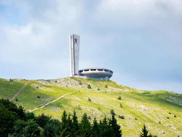 the view from the top of a hill, looking up at a building