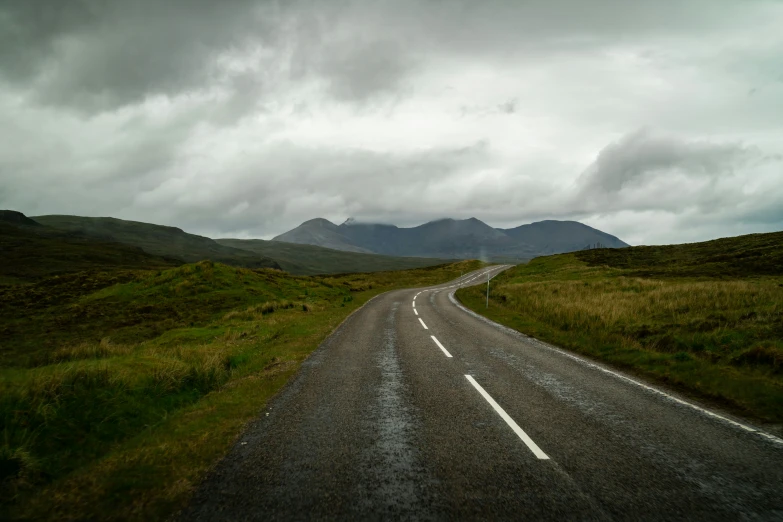 the road is empty on the side of the hill