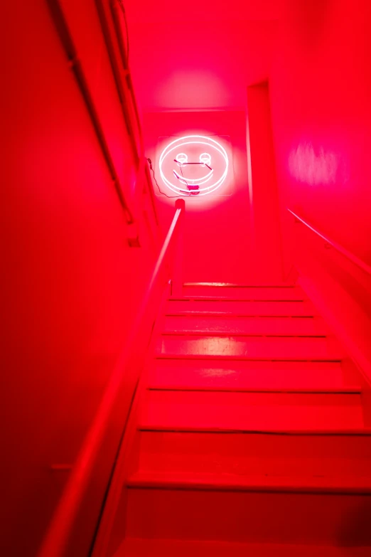 a red light is coming down a small stair case