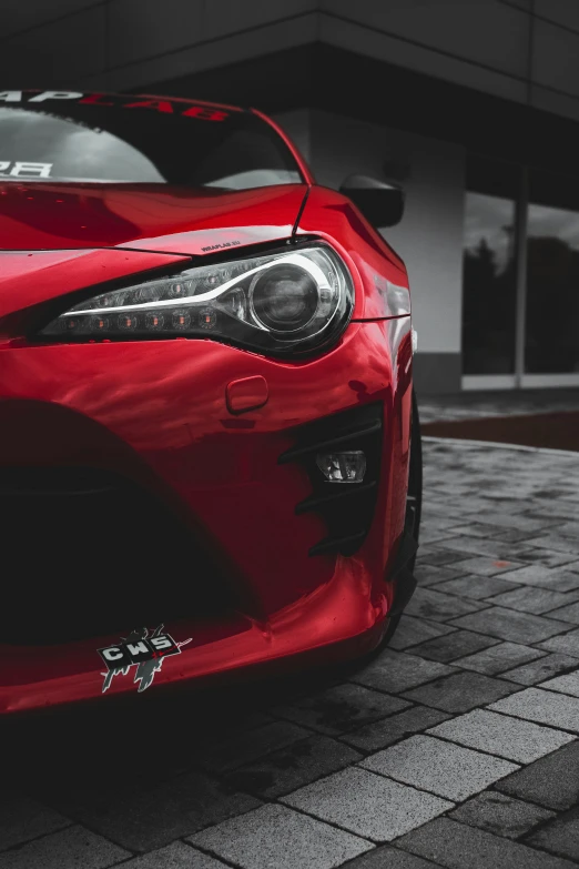 red sports car is parked in a driveway