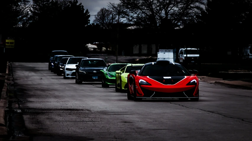 a street lined with parked sports cars in a driveway