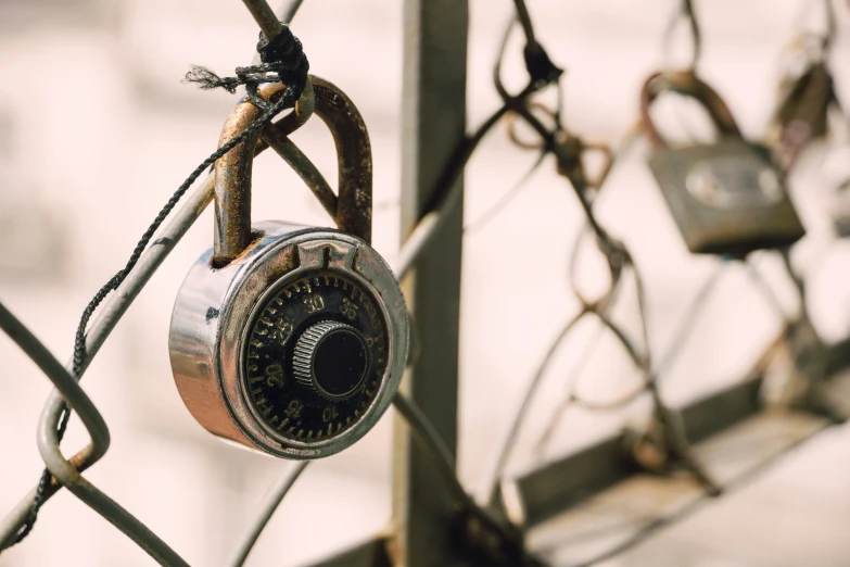 two padlocks are attached to the chain linked fence