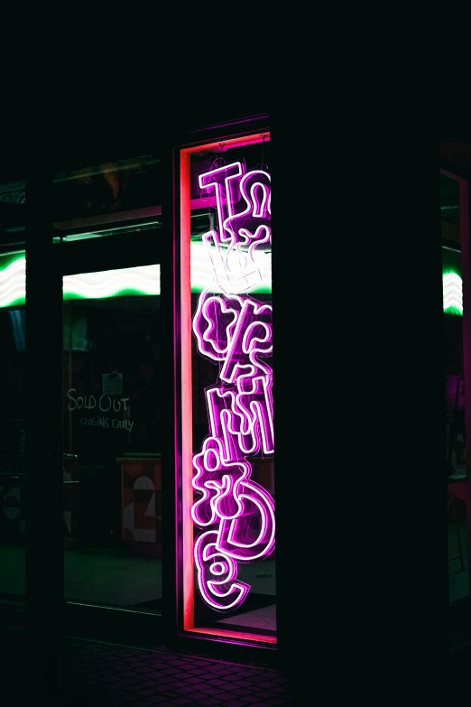 a sign with neon lights is shown in the dark