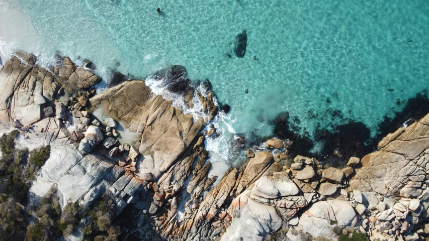 an aerial view of a small beach on the coast