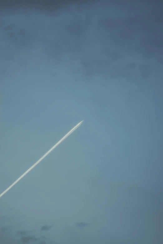 an airplane is flying through the sky at night