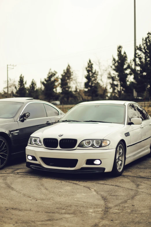 two cars parked side by side with trees in the background