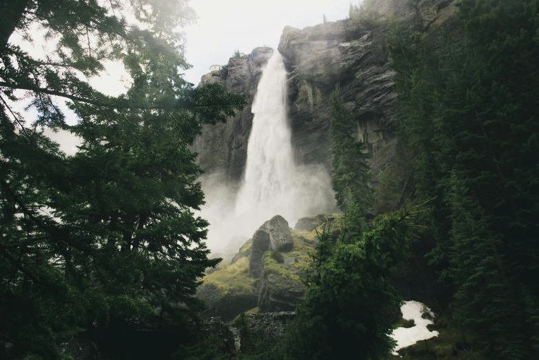 an image of a waterfall in the middle of trees
