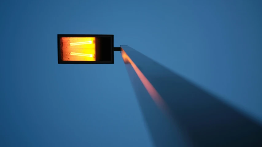 the image shows a street light with a shadow from a lamppost