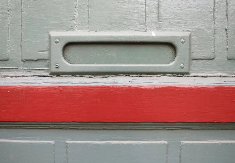 the handle on the door of a red and gray house