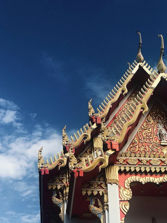 a very ornate building with golden trim against a blue sky